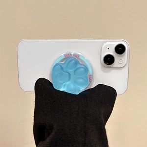 Close-up of a blue cat paw phone grip with Good Luck text on a white smartphone