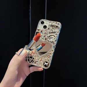 Close-up of luxury rhinestone iPhone case with heart mirror and camellia flower detail