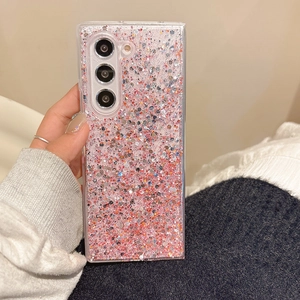 Detail of pink gradient glitter phone case with holographic sequins held in hand