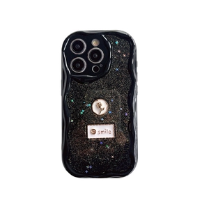 Black glitter iPhone case with wavy edges, gold-edged flower, and smile tag