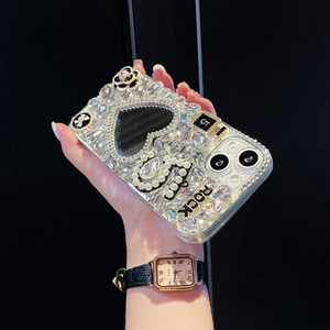 Close-up of luxury iPhone case featuring rhinestones, pearls, mirror heart and camellia