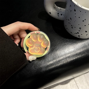 Detail of a colorful cat paw griptok with heart pattern and Good Luck text