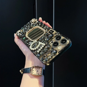 Luxury iPhone case with oversized crystals, makeup mirror, and pearl floral accents