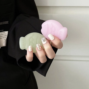 Close-up of cute taiyaki shaped phone grip in pastel pink and soft green colors