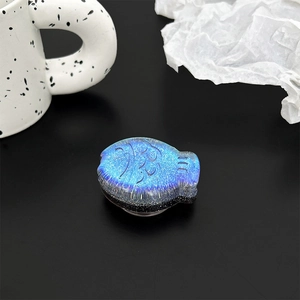 Macro detail of blue glitter resin fish phone grip with holographic sparkling finish