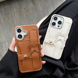 Detail of tan and off-white leather phone case with heart strap and integrated card slots