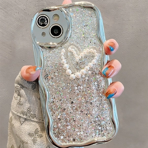Detail of silver wavy phone case with glitter finish and a pearl heart motif on back