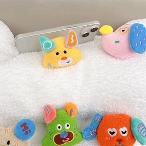 Close-up of cute plush cartoon animal phone grips featuring soft embroidery detail