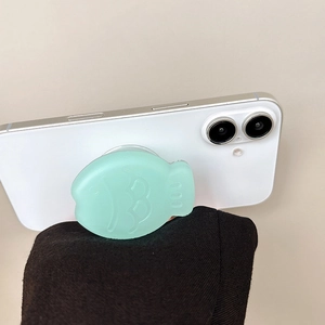 Mint green fish-shaped phone grip socket with 001 engraving on a white smartphone