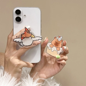 Cute cartoon goose and bear phone grip holders held by model in a warm setting