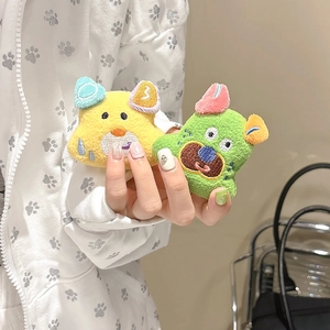 Detail showing plush cartoon puppy phone stand with embroidery and soft texture
