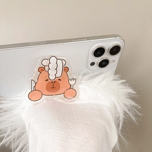 Close-up of a cute cartoon capybara chef phone grip on a white smartphone device