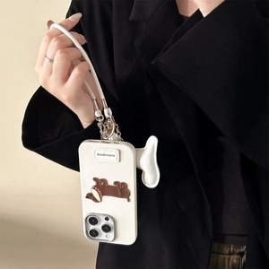 Close-up of white leather-texture iPhone case with dachshund puppy patch and wrist strap