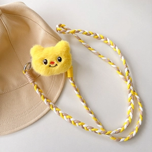 Detail of cute yellow plush cat pendant and thick braided crossbody strap for phone case