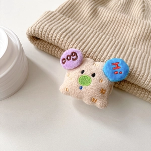 Close-up of cute plush dog phone stand with colorful DOG and HI embroidery details
