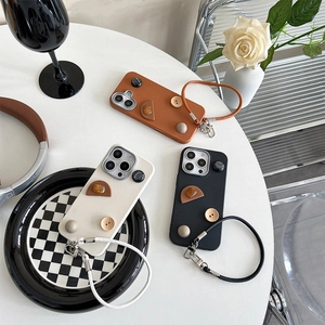 Retro geometric button phone case for iPhone with leather texture and matching hand strap