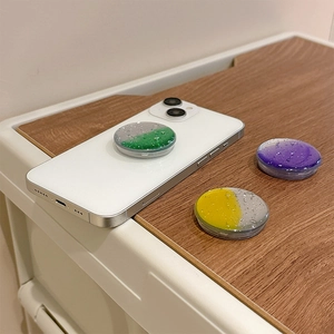 Gradient glitter phone grip with water droplet texture on white smartphone
