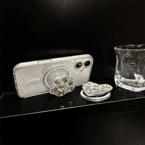 Detail of rhinestone cat paw and heart magnetic phone socket on transparent case