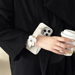 Detail of white silicone iPhone case with heart wristband and leather texture