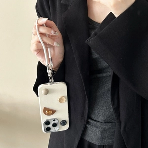 Minimalist cream geometric button phone case with lanyard for iPhone, held by a model