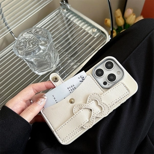Detail view of cream lychee leather iPhone case with functional button wallet and wrist strap