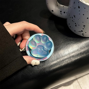 Close-up of translucent blue aurora cat paw phone grip with Good Luck text