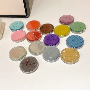 Macro shot of colorful round resin phone grips with sparkling gold foil flakes