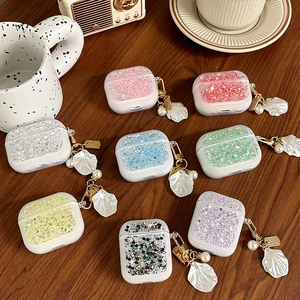 Glittery AirPods case with silver foil sequins, shell pendant and pearl keychain