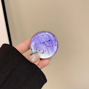 Macro detail of purple gradient phone grip with silver foil and black glitter finish