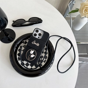 Detail of black quilted silicone iPhone case with crossbody strap and tulip emblem