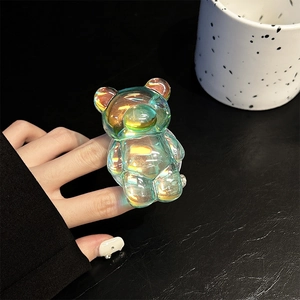 Iridescent laser bear pop socket phone stand shown held by hand with aurora finish