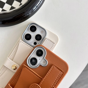 Detail of lychee pattern leather phone case with card slot and wrist strap on white desk