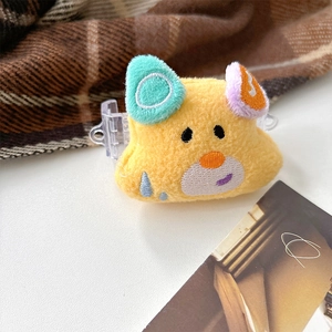 Détail d'une pince à cheveux en peluche jaune avec broderie et oreilles colorées