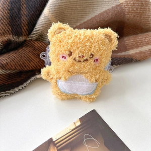 Detail of yellow plush bear earphone case with soft sherpa texture and cute embroidery