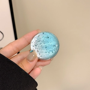 Detail of round phone grip holder with blue silver gradient glitter and silver foil