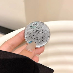 Detail of the silver foil phone grip with artistic black terrazzo stone texture surface
