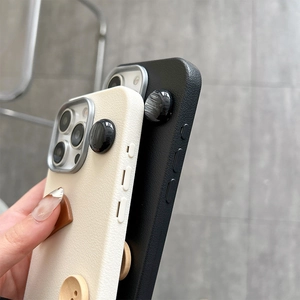 Close-up of side view showing camera protector and button details of leather phone case
