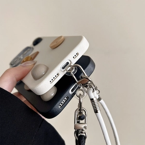 Close-up of leather texture phone case with bottom metal ring and lanyard attachment