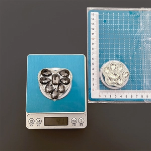 Detail view of heart and cat paw rhinestone phone grips with weight and size scale