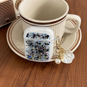 Detailed view of glitter AirPods case with pearl shell pendant and gold metal carabiner