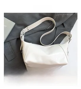 Detail view of cream-colored PU leather Hobo bag with adjustable wide shoulder strap
