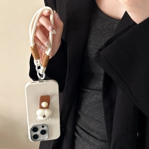 Detail of cream iPhone case with 3D bear ornament and thick white braided wrist strap