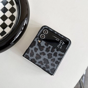 Detail of leopard print leather case for folding phones on minimalist white background