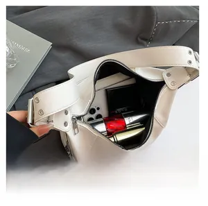Internal view of cream leather crescent bag showing large capacity for essentials