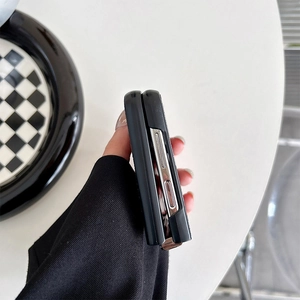 Close-up of black folding case side buttons and precise cutouts for Samsung Z Flip