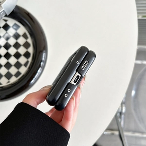 Close-up of black leather case for folding phone showing precise USB-C and speaker cutouts