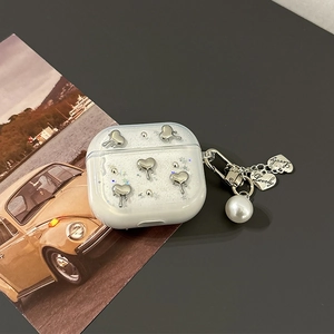 Detail of glitter AirPods case featuring silver heart relief and white pearl charm