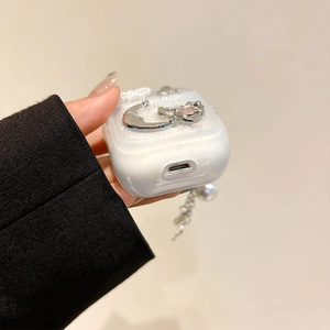Detail view of pearlescent AirPods Pro 2 case with silver moon and heart charms