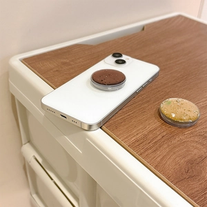 Detail of glitter and rock texture phone grip tok on a smartphone with clear base