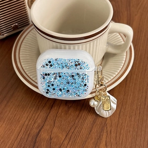 Detail of AirPods case with blue silver glitter, pearl keychain and seashell pendant